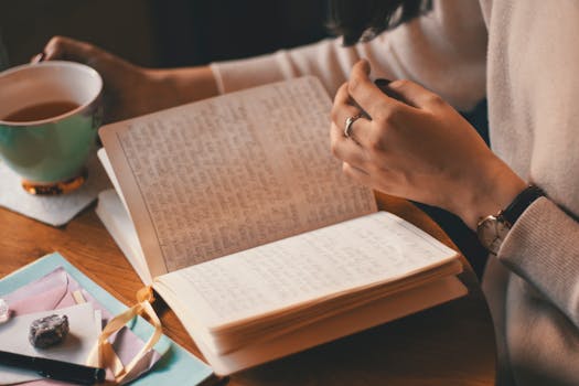 person journaling with a cup of tea