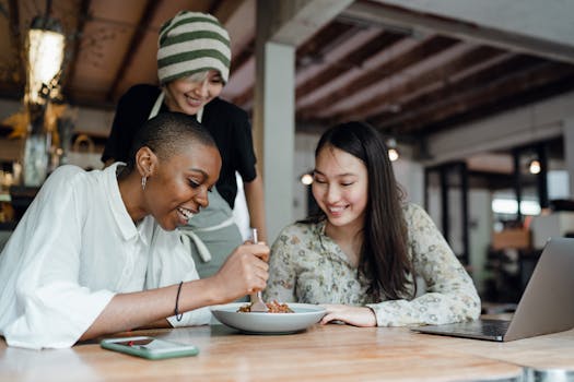 group of friends laughing in a cozy cafe