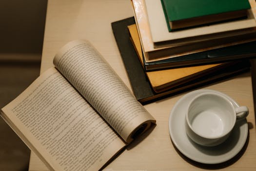 stack of books with a cup of coffee