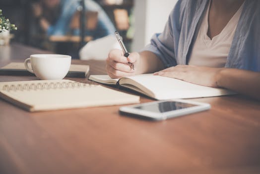 person journaling in a quiet café