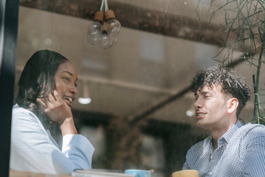 two friends sharing a laugh over coffee